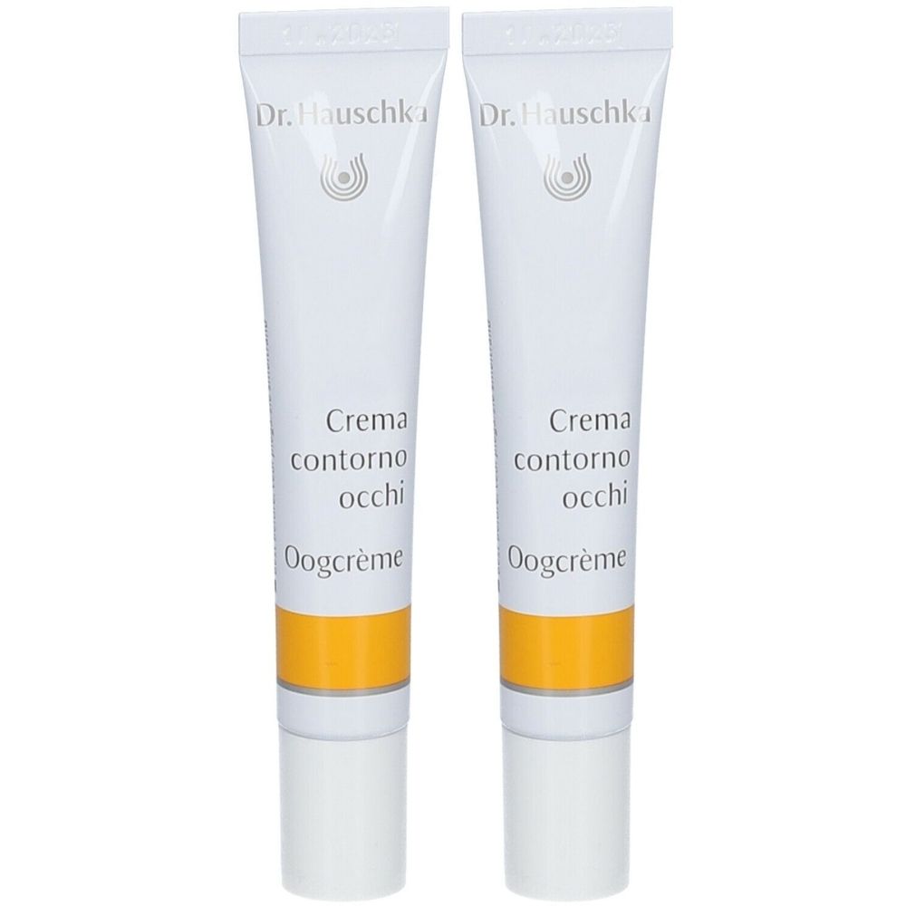 Deux tubes de crème pour les yeux. Blancs, avec une bande jaune et du texte. Marque : Dr. Hauschka. Texte : Crema contorno occhi, Oogcrème.