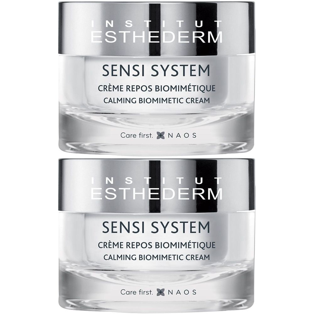 Deux pots de crème INSTITUT ESTHEDERM SENSI SYSTEM. Couvercle argenté, pots transparents. Texte: CRÈME REPOS BIOMIMÉTIQUE, CALMING BIOMIMETIC CREAM.