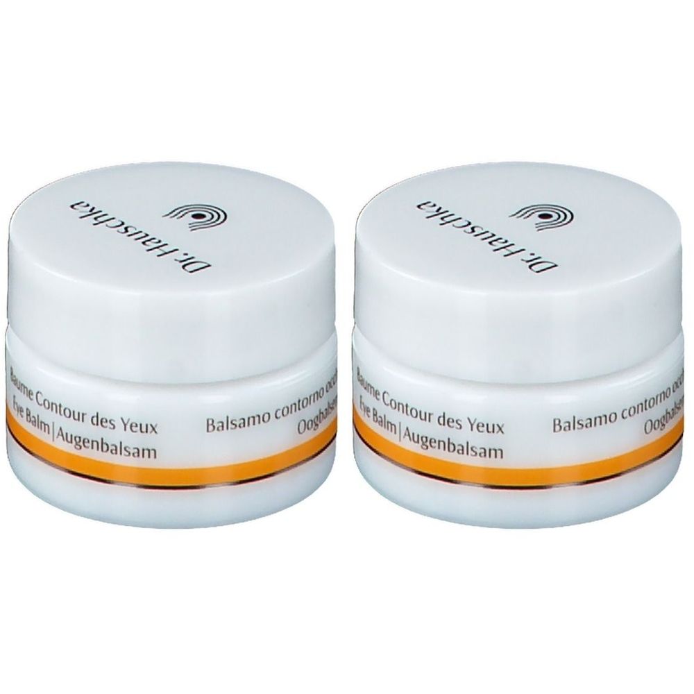 Deux pots blancs avec couvercles. Inscription: Dr. Hauschka, Baume Contour des Yeux, Augenbalsam. Bande orange.