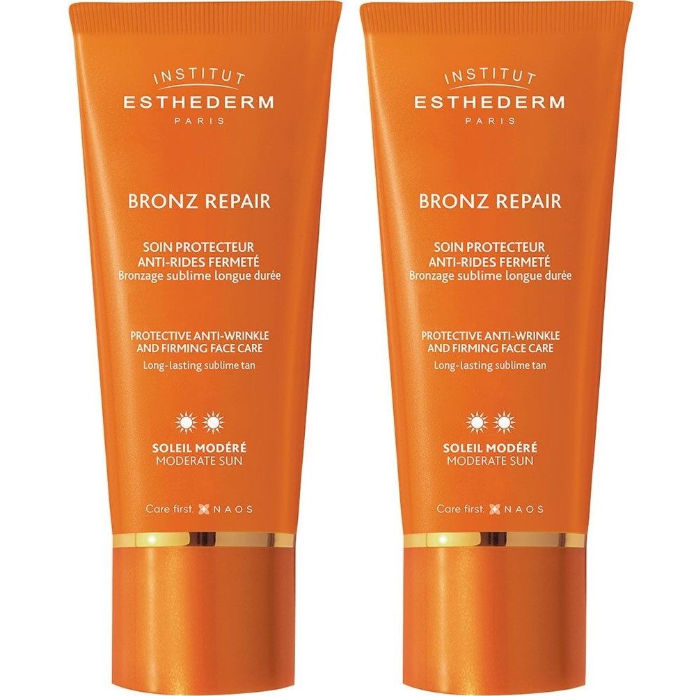 Deux tubes de crème solaire orange. Inscriptions: BRONZ REPAIR, SOLEIL MODÉRÉ, INSTITUT ESTHEDERM. Protection anti-rides.