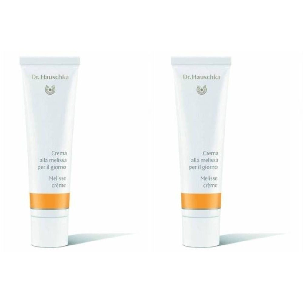 Deux tubes de crème. Inscription: Dr. Hauschka, Crème à la Mélisse. Tube blanc avec bande orange.