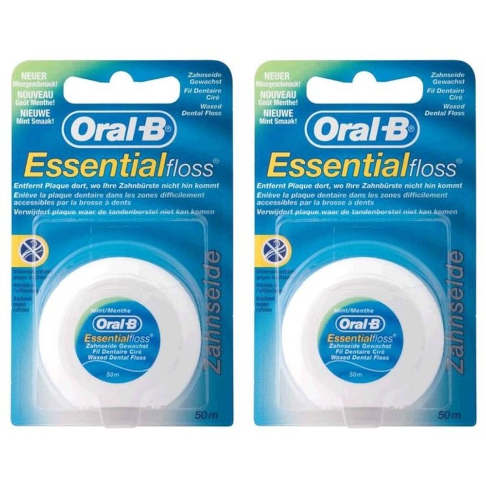 Deux paquets de fil dentaire Oral-B Essentialfloss. Bobines blanches dans un emballage plastique. Texte: Essentialfloss, 50m.