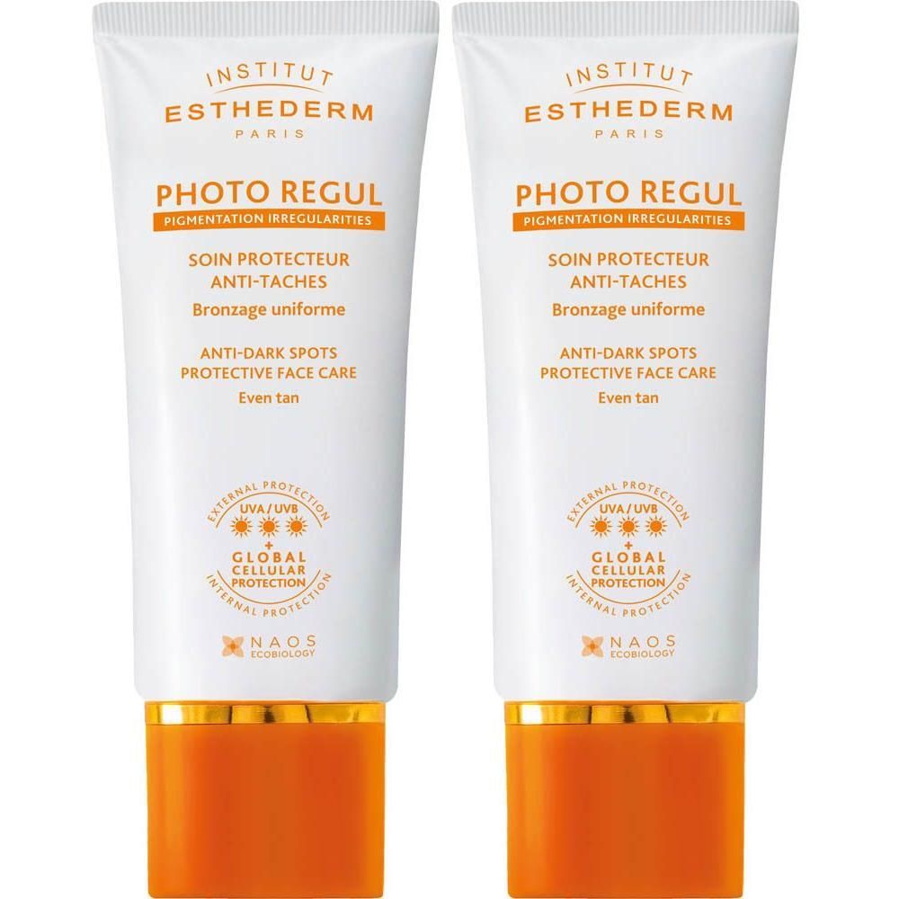 Deux tubes Institut Esthederm Photo Regul. Tubes blancs avec éléments orange et dorés. Texte: Photo Regul, Anti-Taches, NAOS.