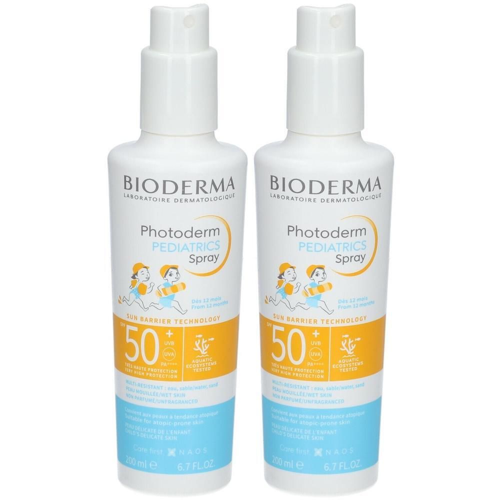Deux flacons de Bioderma Photoderm Pediatrics Spray SPF50+. Flacons blancs avec vaporisateur, étiquette jaune et bleue.