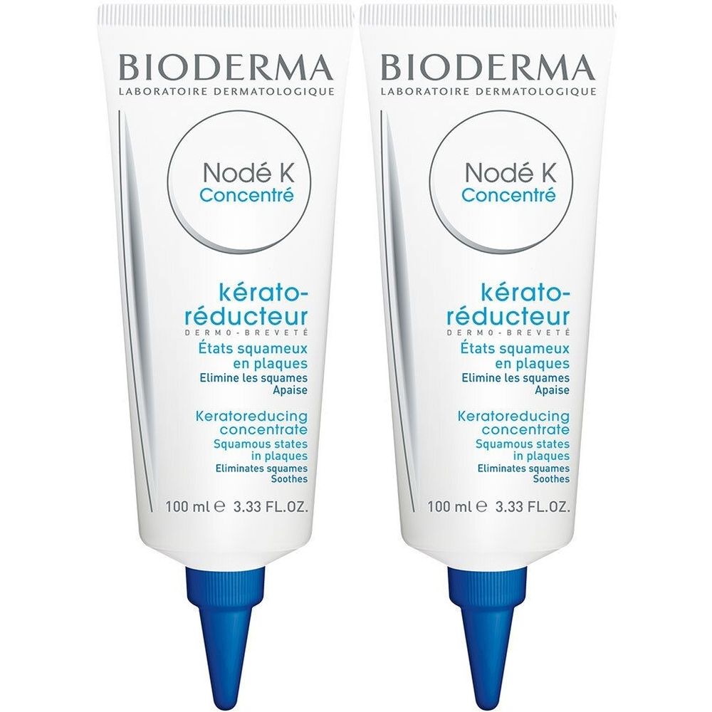 Deux tubes de BIODERMA Nodé K Concentré. Tubes blancs avec embout bleu. Texte : kérato-réducteur, 100 ml.