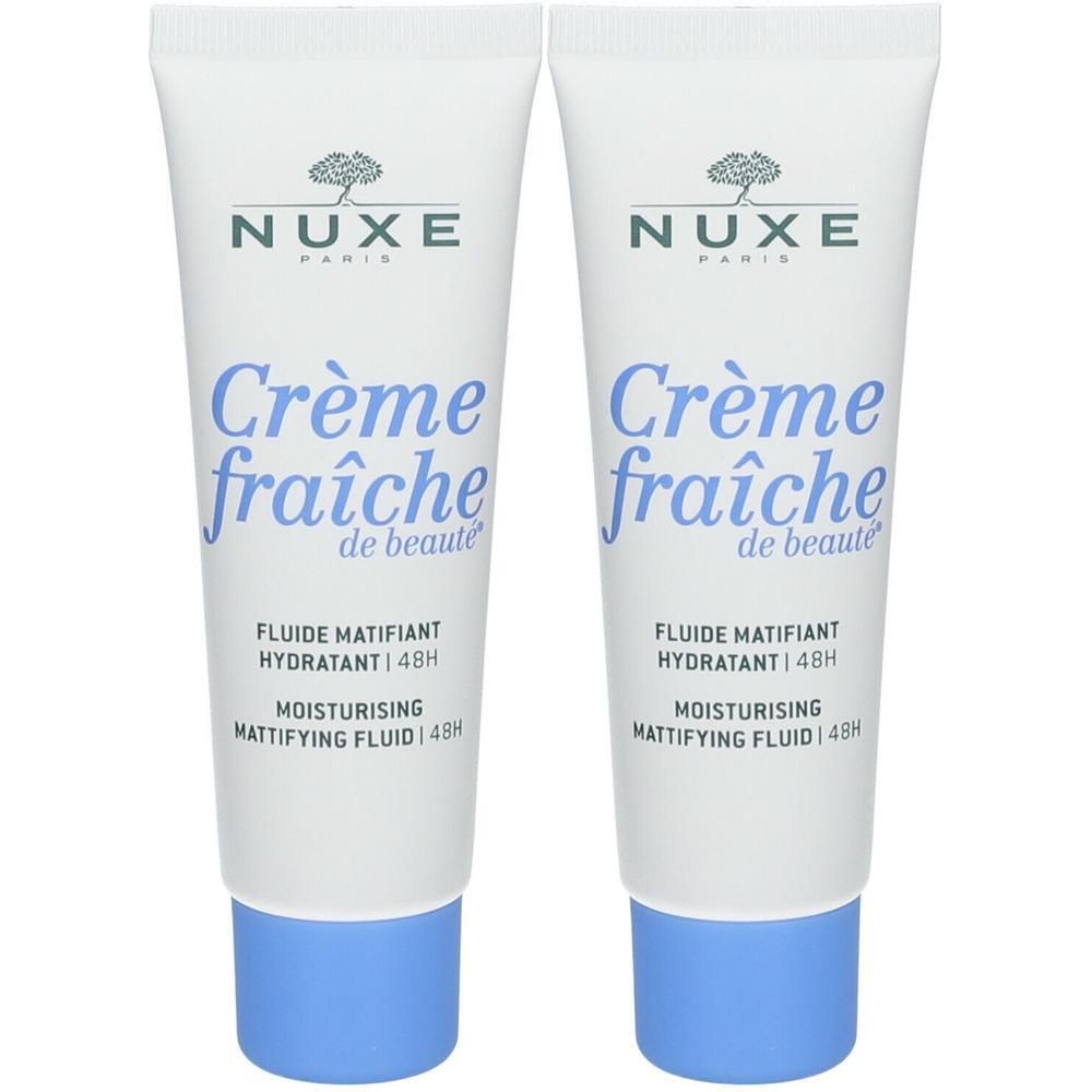 Deux tubes de Nuxe Crème Fraîche de Beauté. Blancs, bouchons bleus, texte visible. Nom du produit et marque apparents.