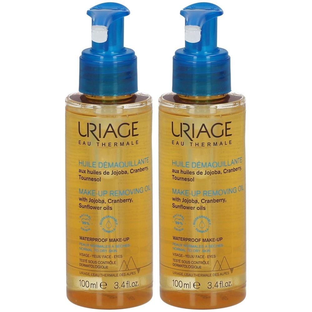 Deux flacons de URIAGE HUILE DÉMAQUILLANTE. Liquide transparent, pompes bleues. Inscription : MAKE-UP REMOVING OIL.