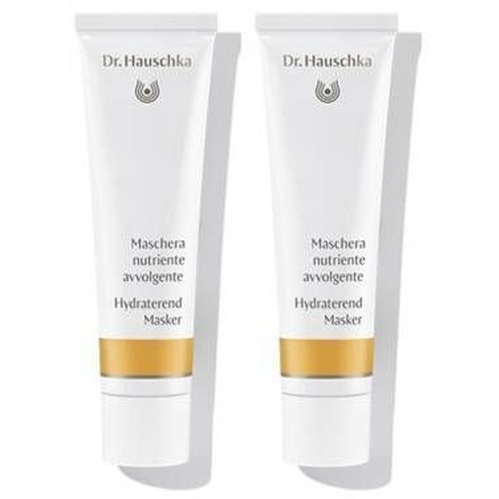 Deux tubes blancs côte à côte. Le logo "Dr. Hauschka" et des inscriptions multilingues sont visibles sur chaque tube.