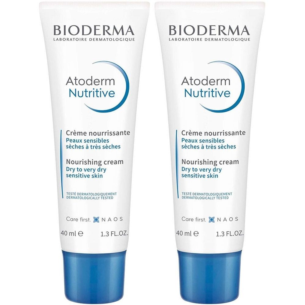 Deux tubes de crème Bioderma Atoderm Nutritive. Tubes blancs avec accents bleus et inscriptions. Contient 40 ml.