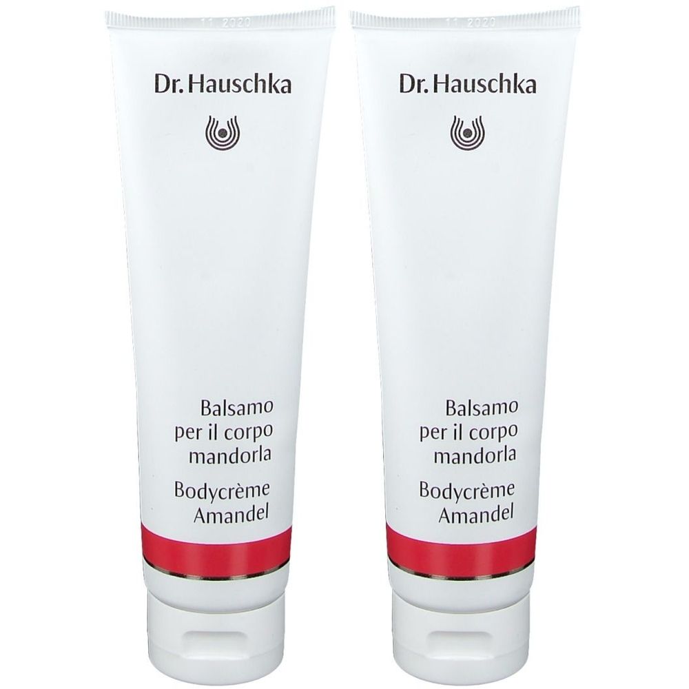 Deux tubes de crème pour le corps. Blancs, avec une bande rouge et du texte. Marque : Dr. Hauschka. Inscription : Balsamo per il corpo mandorla, Bodycrème Amandel.