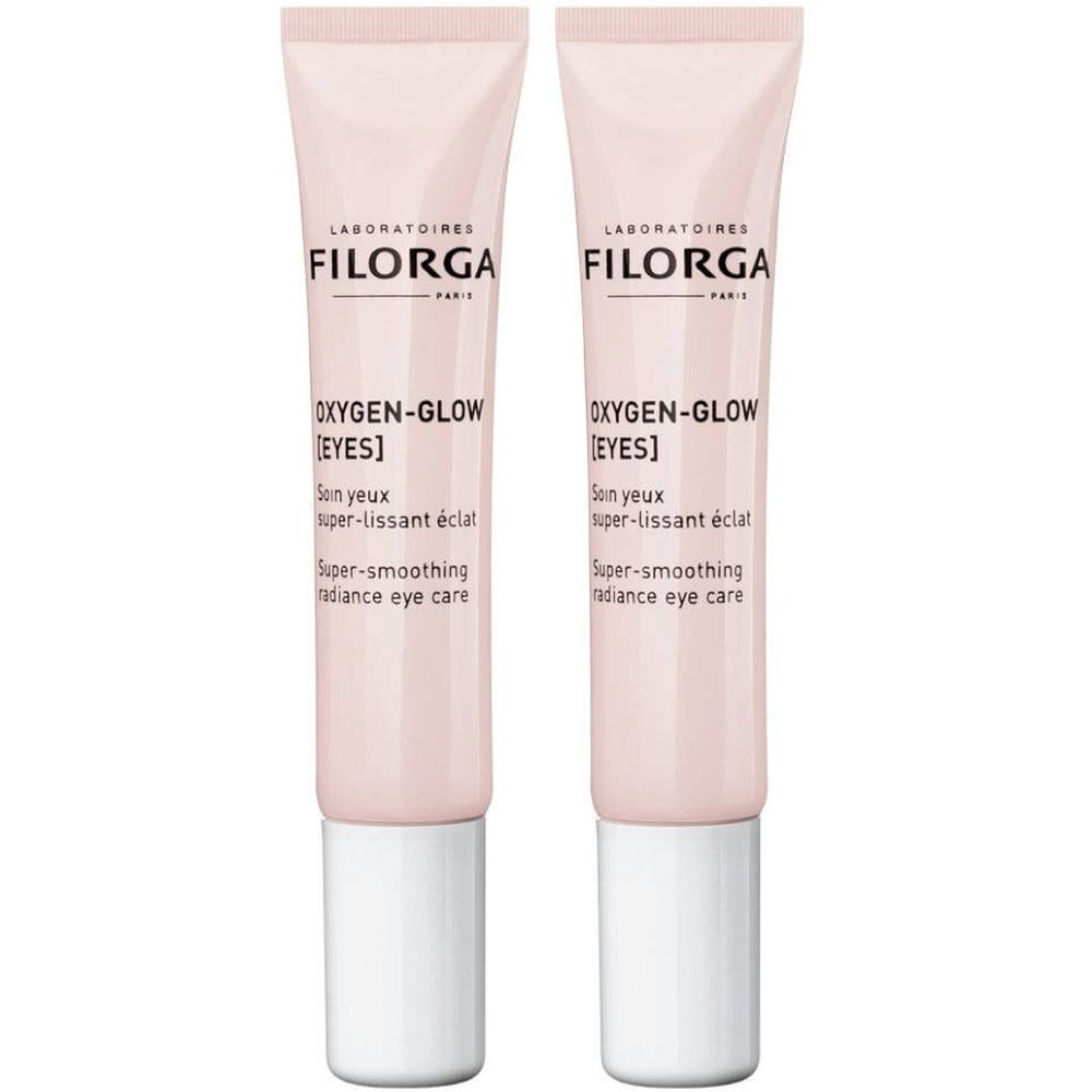 Deux tubes de soin pour les yeux. Tubes roses avec bouchons blancs. Inscription : FILORGA, OXYGEN-GLOW [EYES], Super-smoothing radiance eye care.