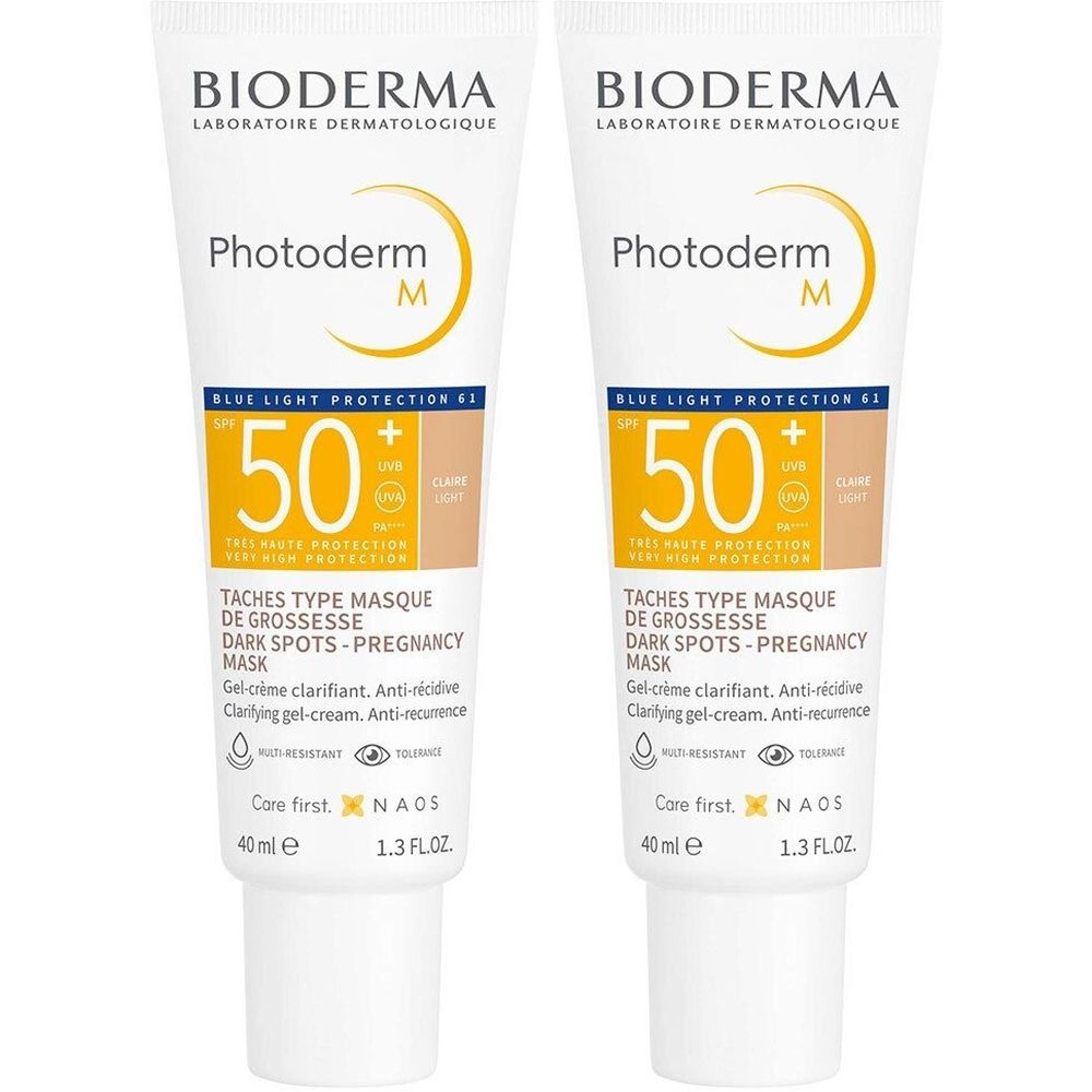 Deux tubes de BIODERMA Photoderm M Gel-Crème Clarifiant SPF50+ Teinte Claire. Tubes blancs avec texte jaune et informations produit.