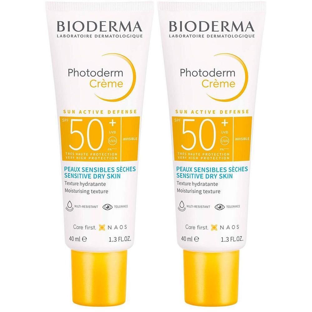 Deux tubes de Bioderma Photoderm Crème. Blanc, bouchon jaune. Texte et logo sur le devant.