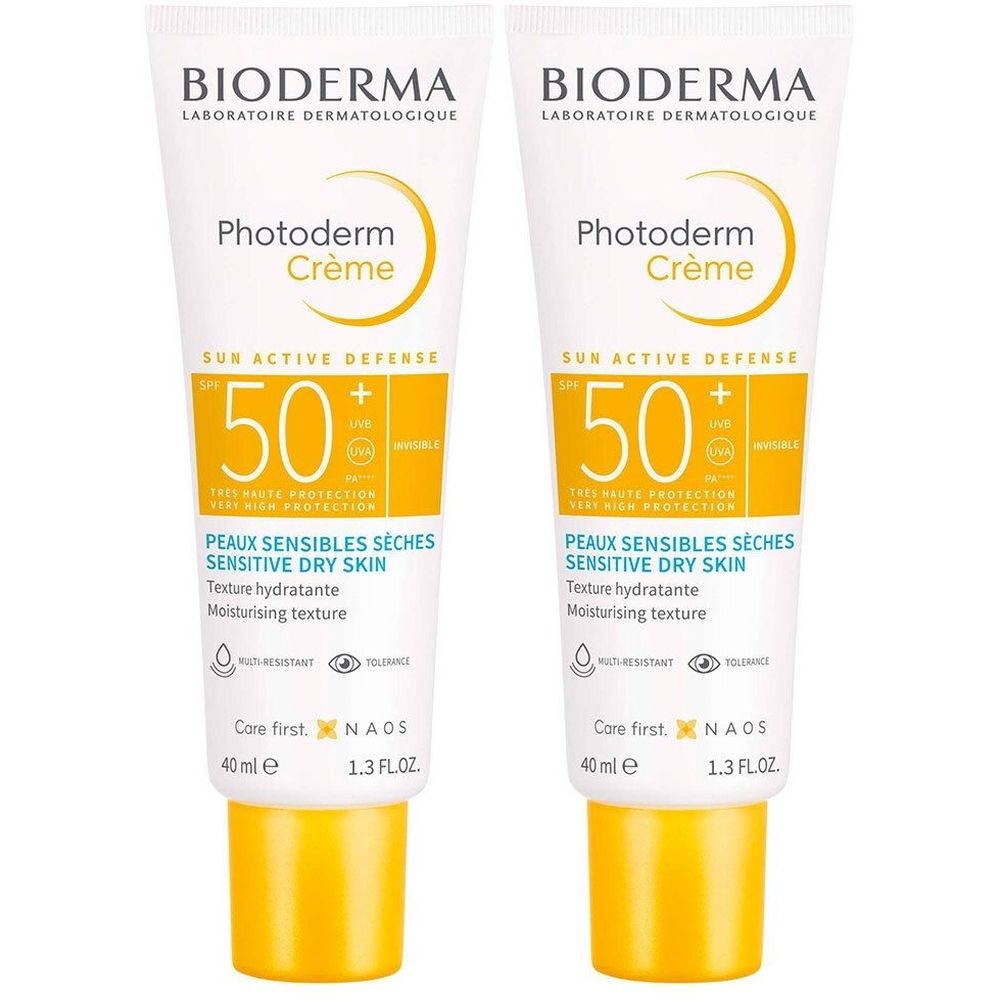 Deux tubes de BIODERMA Photoderm Crème SPF50+. Tubes blancs avec accents jaunes. Texte et logo visibles.