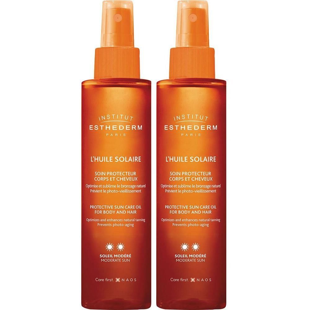 Deux flacons d'huile solaire. Têtes de pulvérisation orange, bouteilles marron avec texte blanc. Institut Esthederm.