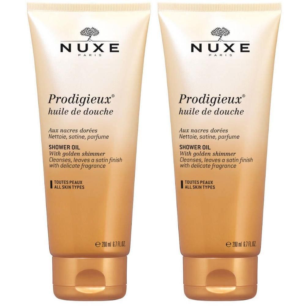 Deux tubes de NUXE Prodigieux® huile de douche. Couleur beige doré, texte et nom du produit. 200 ml.