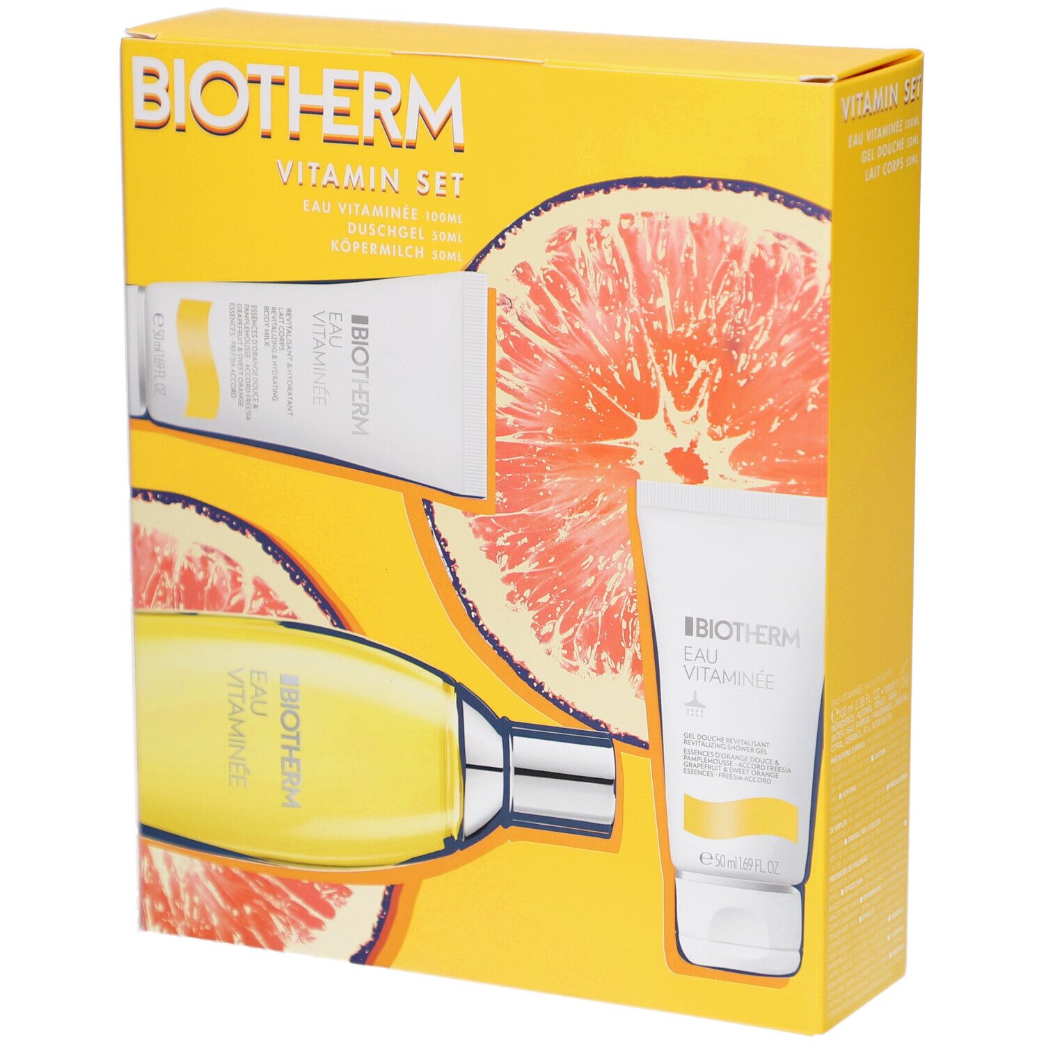 Boîte jaune avec logo BIOTHERM et nom du produit. Contient flacon et tubes. Design pamplemousse. Texte: Eau Vitaminée.