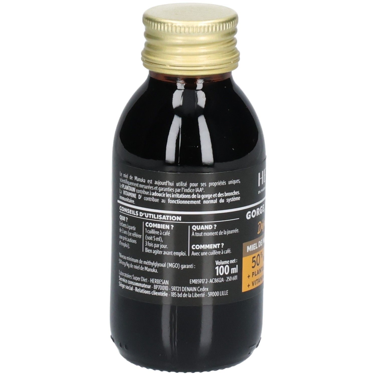 Vue arrière de la bouteille en verre brun avec bouchon doré. Étiquette avec informations produit et mode d'emploi.