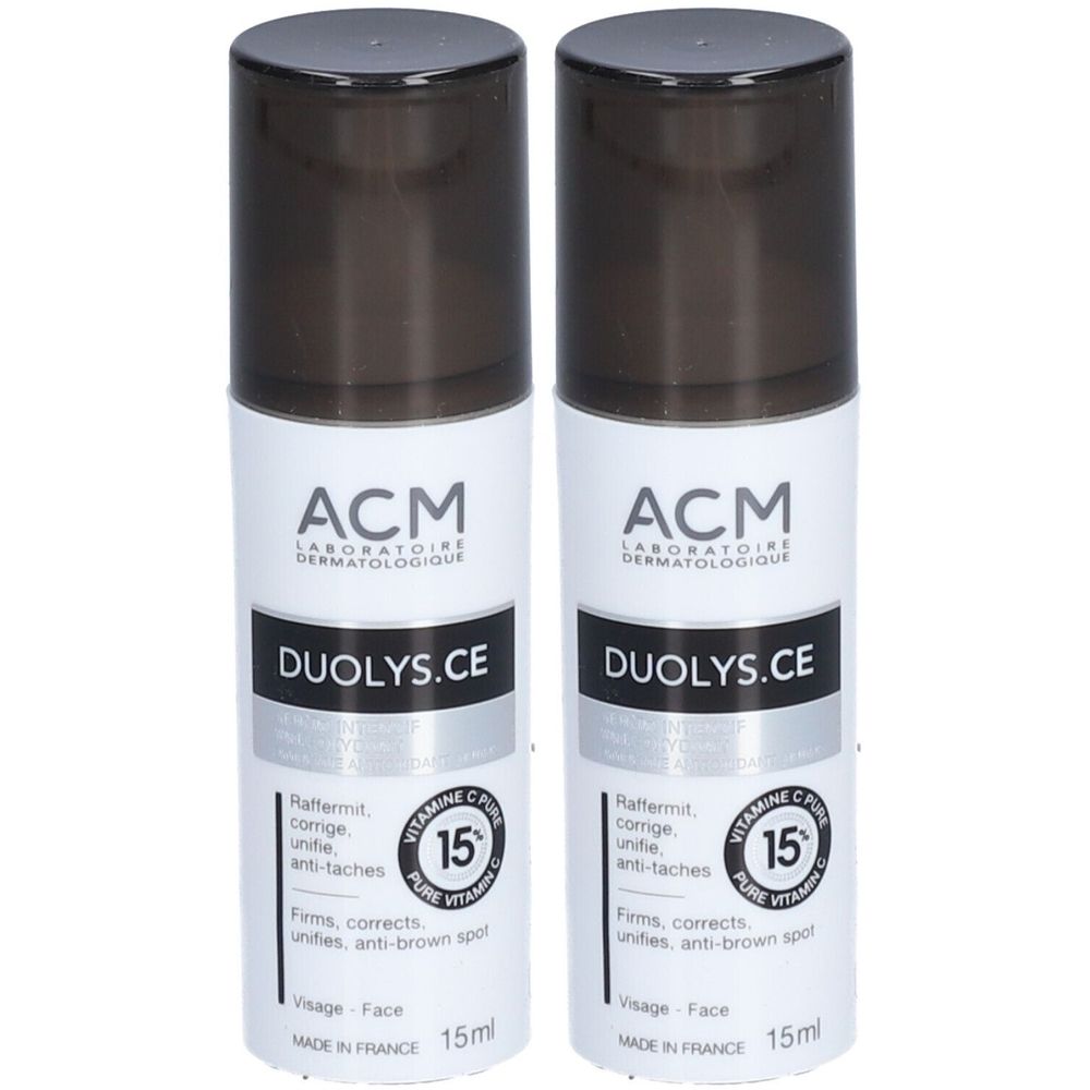 Deux flacons blancs avec bouchon noir. Inscription: ACM, DUOLYS.CE, 15% vitamine C. Texte en français. 15ml.