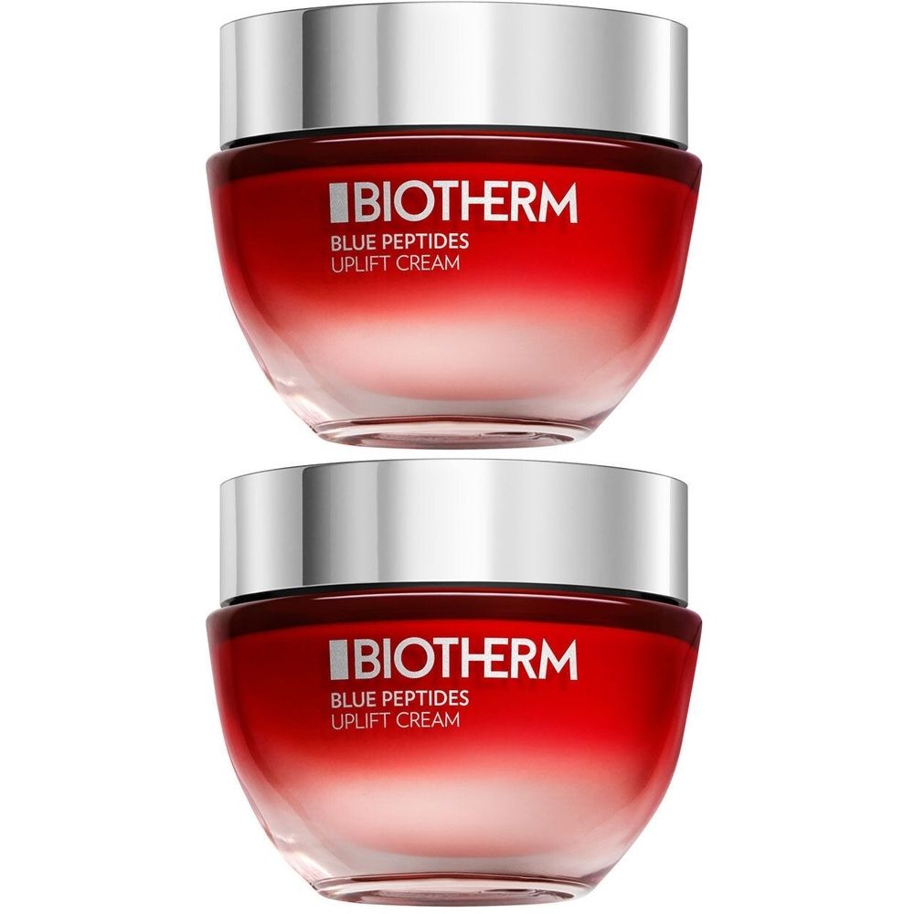 Deux pots avec couvercles argentés et contenu rouge. Inscription: BIOTHERM, Blue Peptides, Uplift Cream.