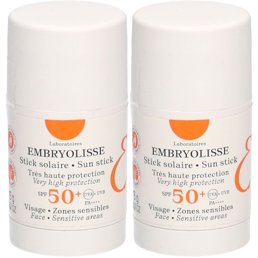 Deux sticks solaires Embryolisse SPF50+. Récipient blanc avec accent orange. Texte: SPF 50+, Très haute protection, Visage, Zones sensibles.