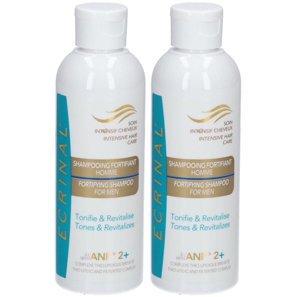 Deux flacons blancs avec des accents bleu-vert. Inscription: Shampooing Fortifiant Homme, Fortifying Shampoo For Men. Logo doré.