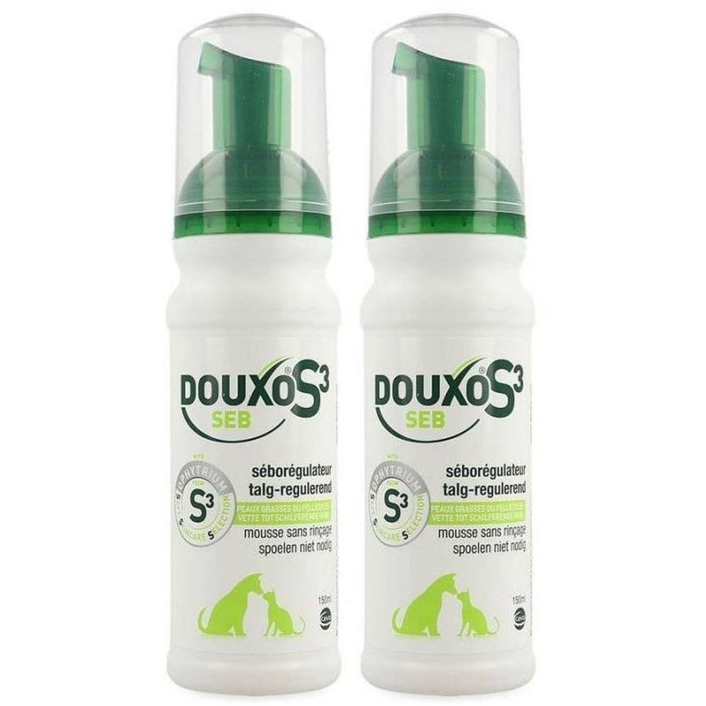 Deux flacons blancs avec vaporisateur vert. Inscription: Douxo S3 SEB. Texte en français et néerlandais.