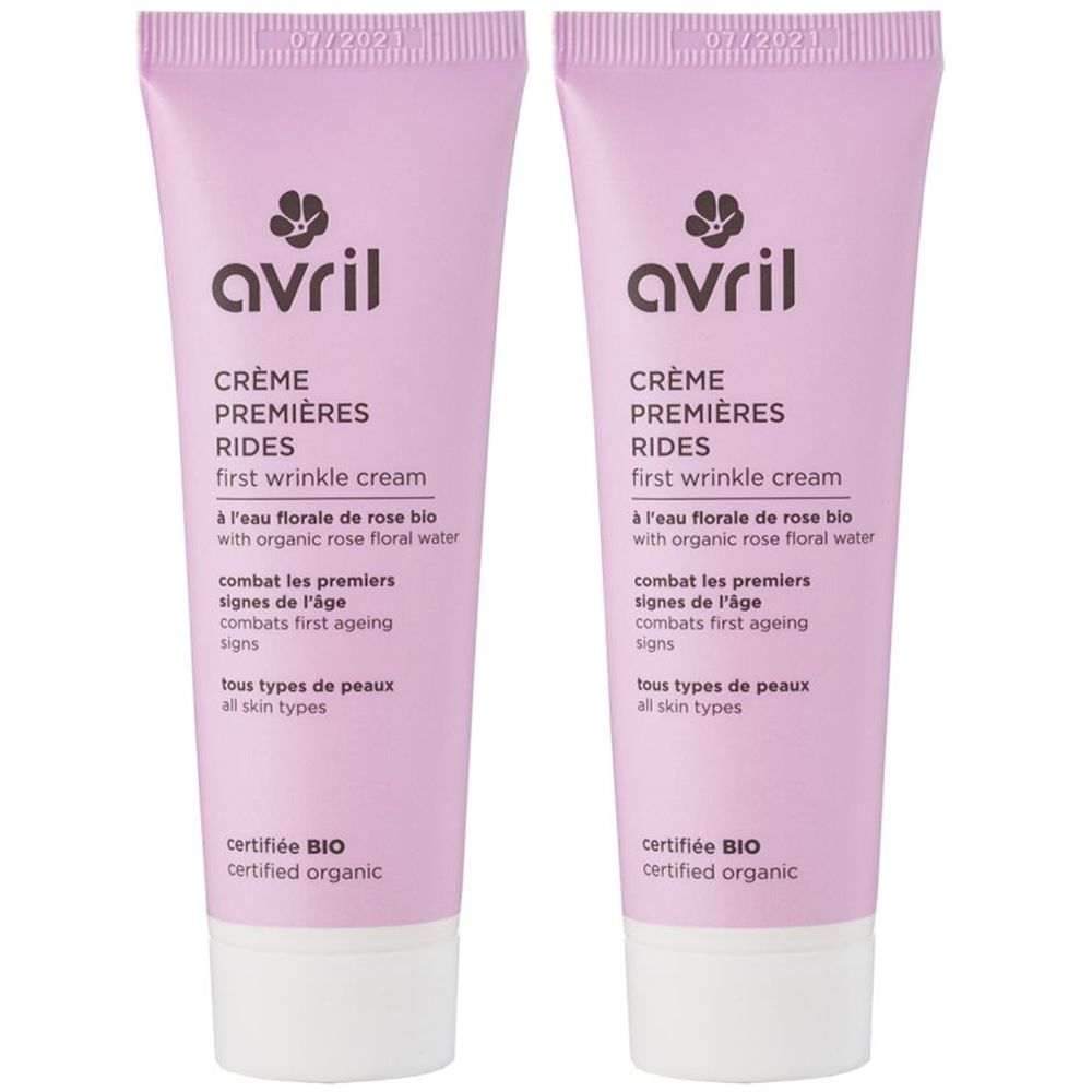 Deux tubes de crème Premières Rides Avril. Tubes roses avec bouchon blanc. Texte: Crème Premières Rides, certifié Bio.