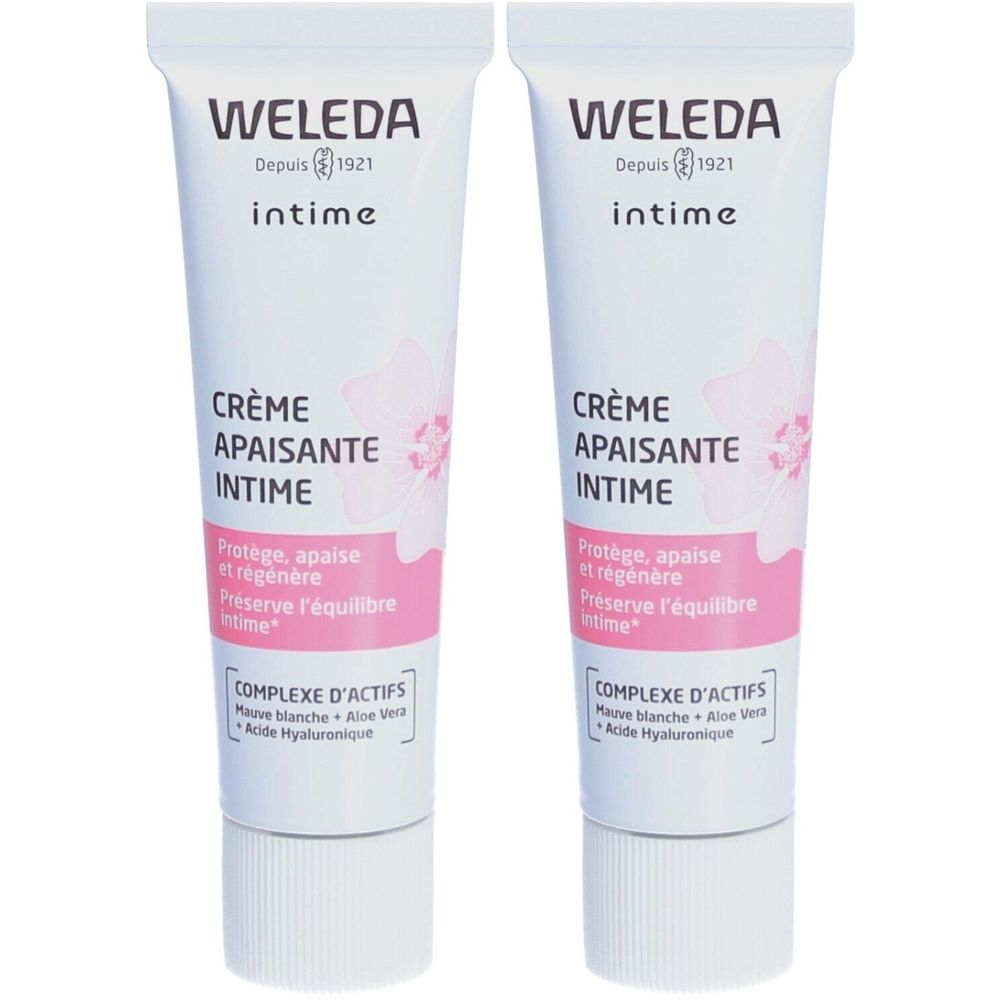 Deux tubes de crème intime WELEDA. Tubes blancs avec accents roses et verts. Inscription : Crème Apaisante Intime.