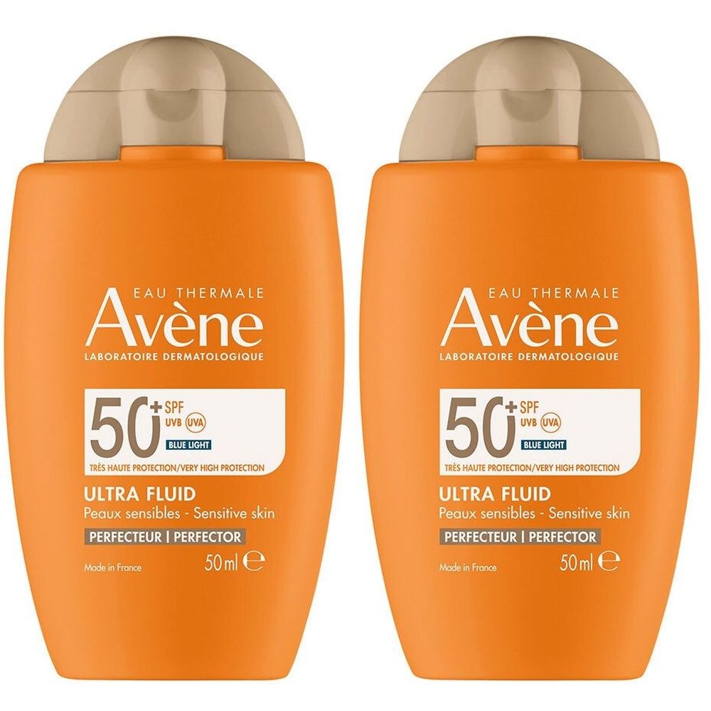 Deux flacons orange AVÈNE Ultra Fluid Perfector SPF 50+. Inscriptions : 50+ SPF, Ultra Fluid, peaux sensibles. Bouchon beige.
