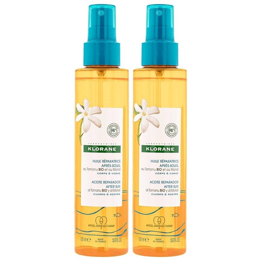 Deux flacons spray de liquide jaune. Têtes de pulvérisation bleues. Inscription: KLORANE, HUILE REPARATRICE APRES-SOLEIL. Illustrations de fleurs blanches.