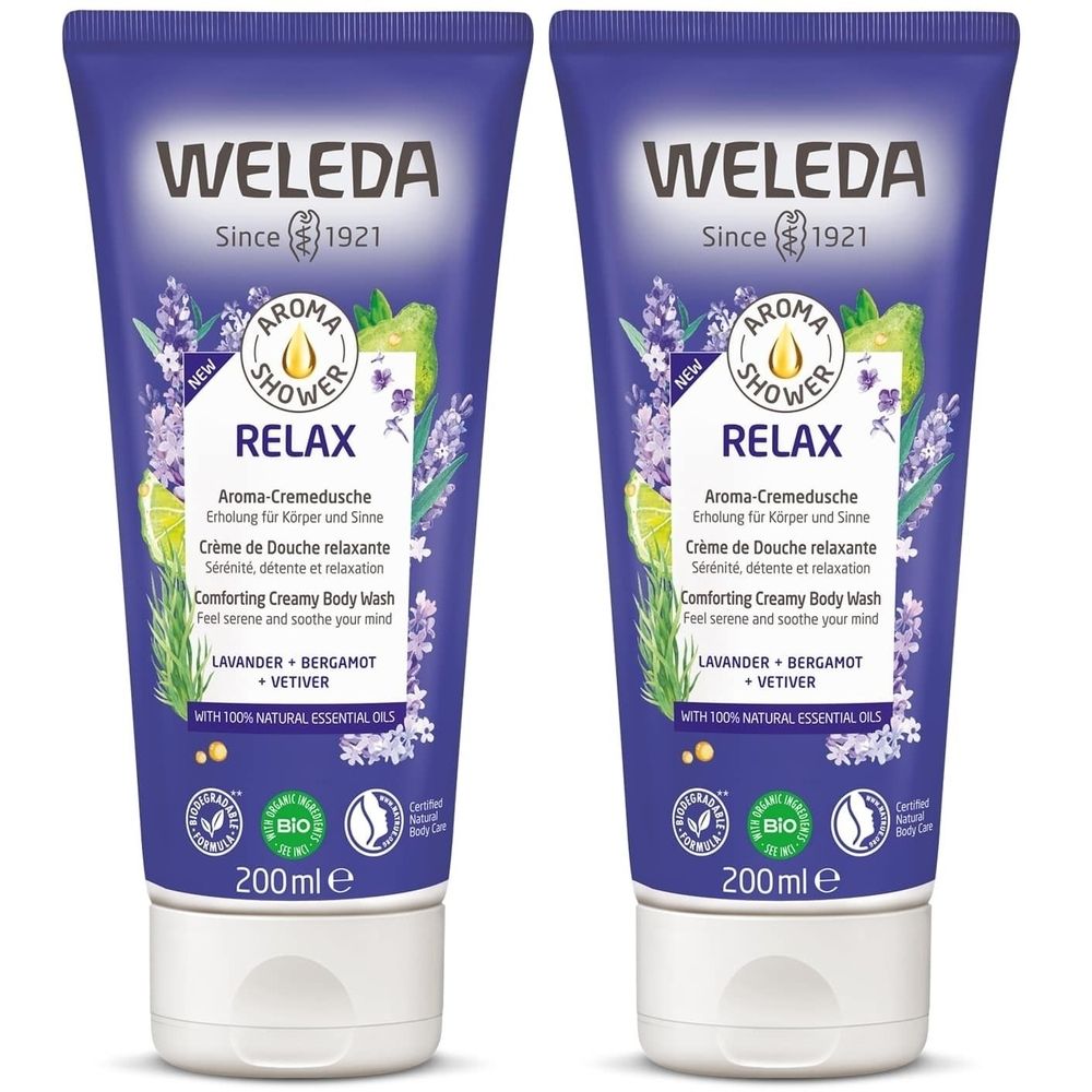 Deux tubes de crème de douche WELEDA RELAX. Tubes violets avec bouchon blanc. Texte: RELAX, label BIO, 200ml.