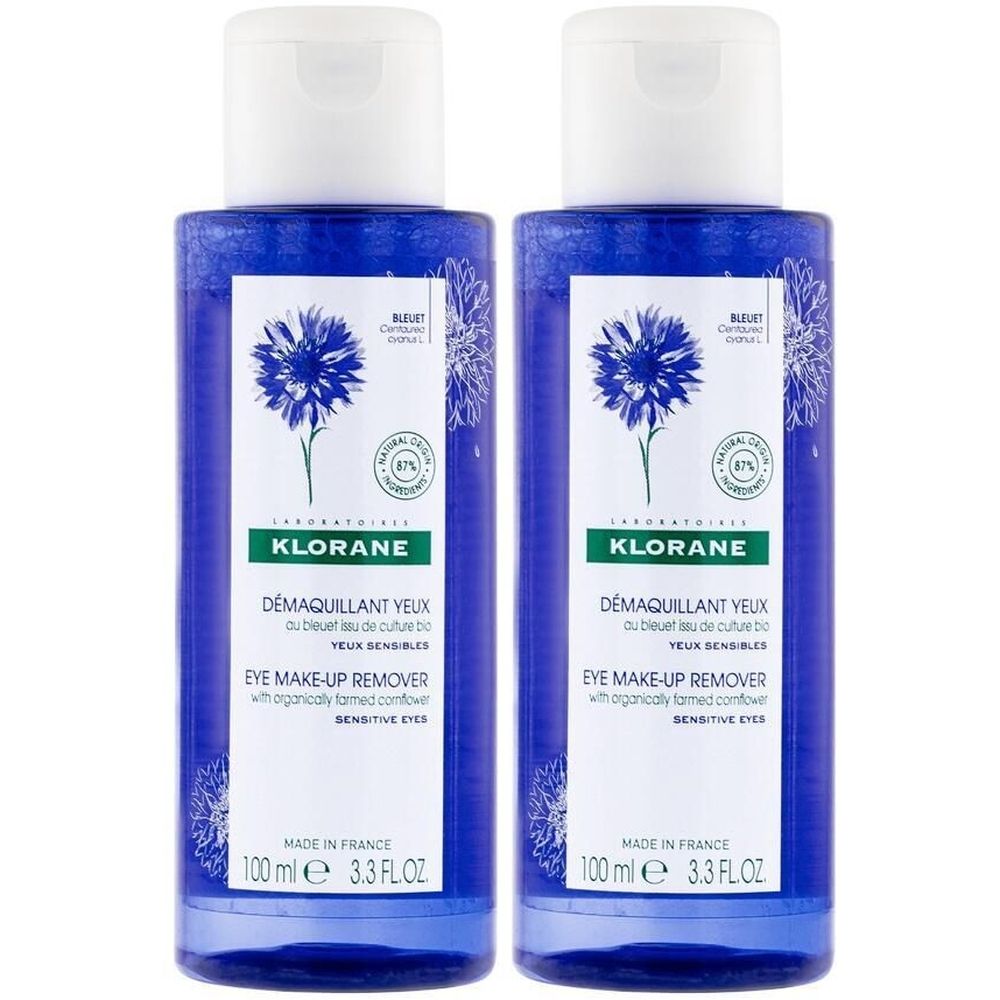 Deux flacons bleus avec bouchons blancs. Inscription: KLORANE, Démaquillant Yeux, Eye Make-up Remover. Motif bleuet.