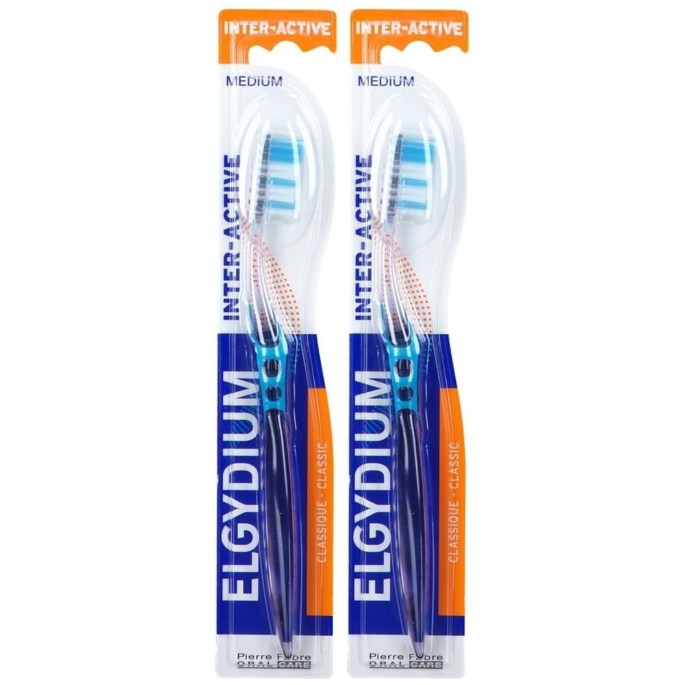 Deux brosses à dents sous blister. Manches bleus, soies blanches avec bandes bleues. Inscription: ELGYDIUM INTER-ACTIVE.