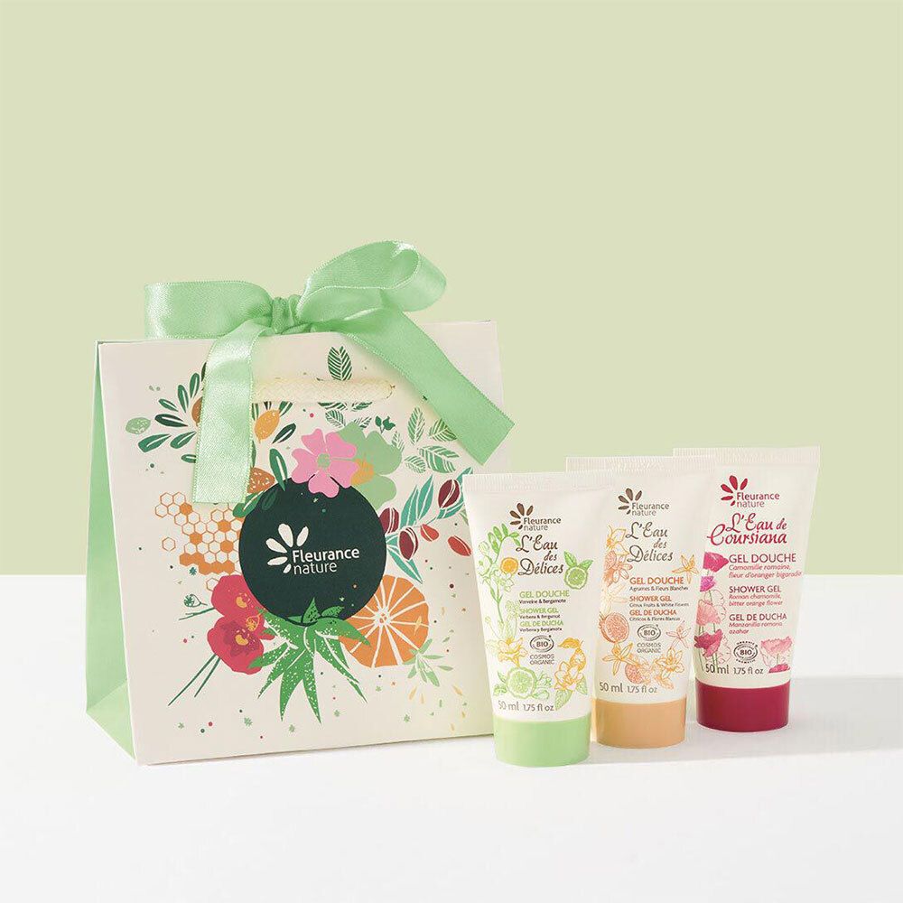 Coffret cadeau avec trois gels douche et un sac en papier à motifs floraux et ruban. La marque est FLEURANCE Nature.