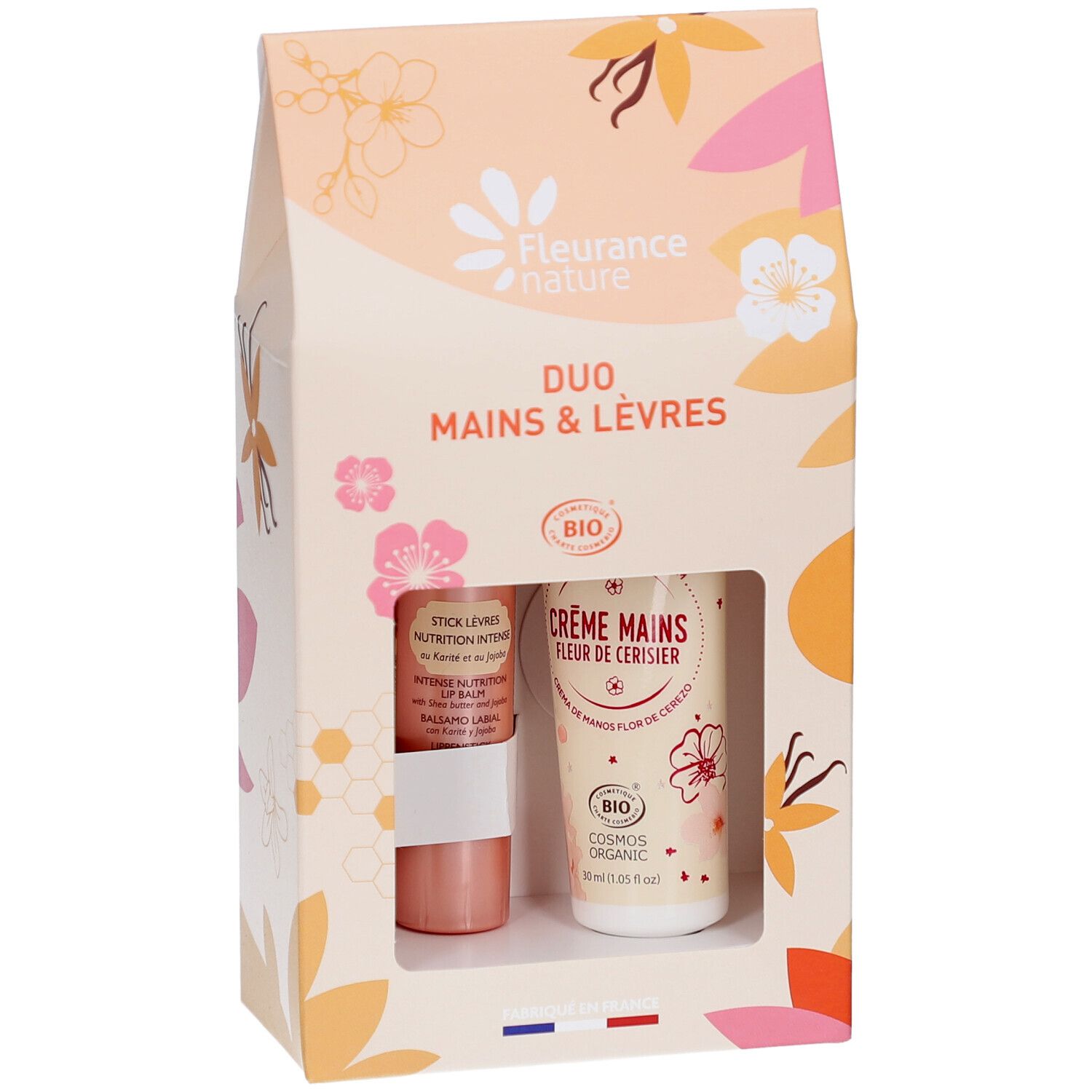 Coffret Duo Mains & Lèvres. Contient crème mains et stick lèvres. Produits visibles dans la fenêtre.