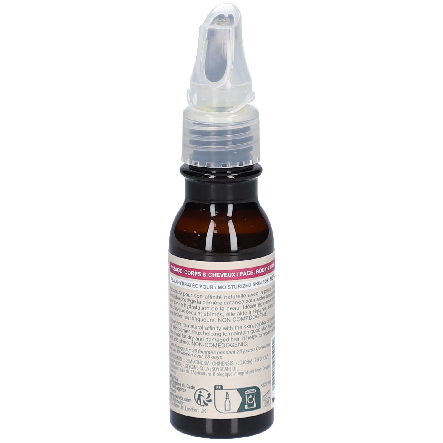 Flacon en verre brun avec vaporisateur. Étiquette avec texte. Contient des informations pour le visage, le corps et les cheveux. Bio.