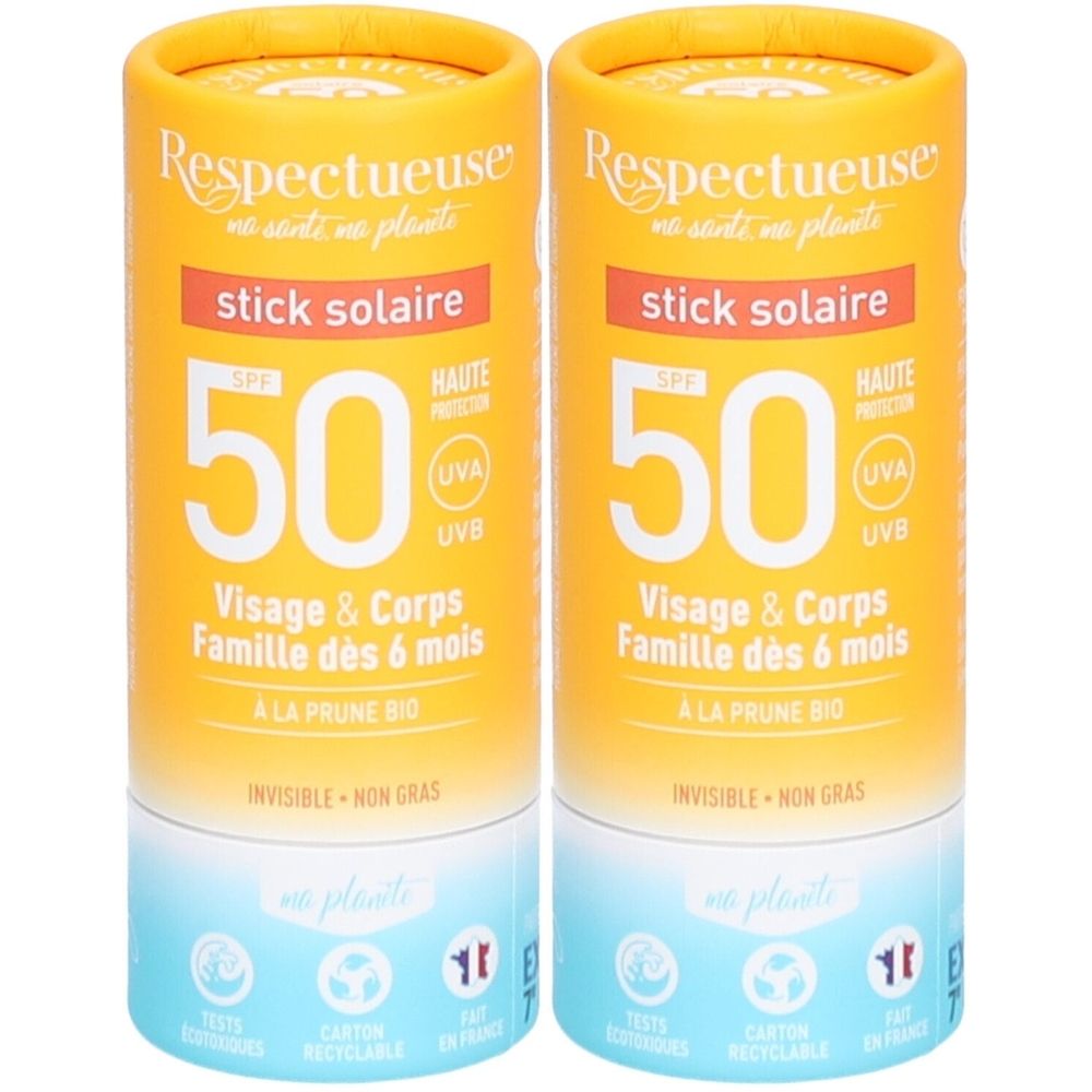 Deux sticks solaires cylindriques. Emballage jaune-orangé avec texte : stick solaire, SPF 50, Visage & Corps, et logo.