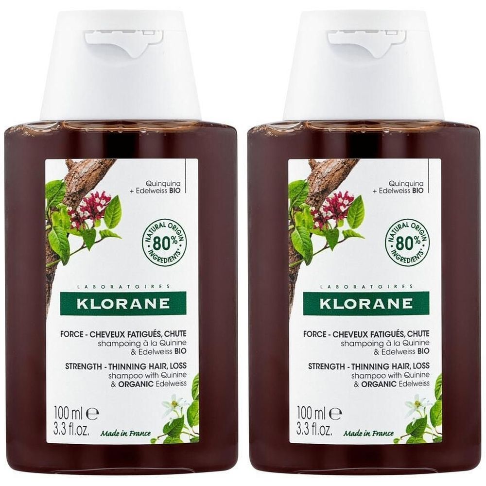 Deux flacons de shampoing KLORANE marron. Étiquettes avec texte et illustrations. Ingrédients naturels à 80%. 100 ml.
