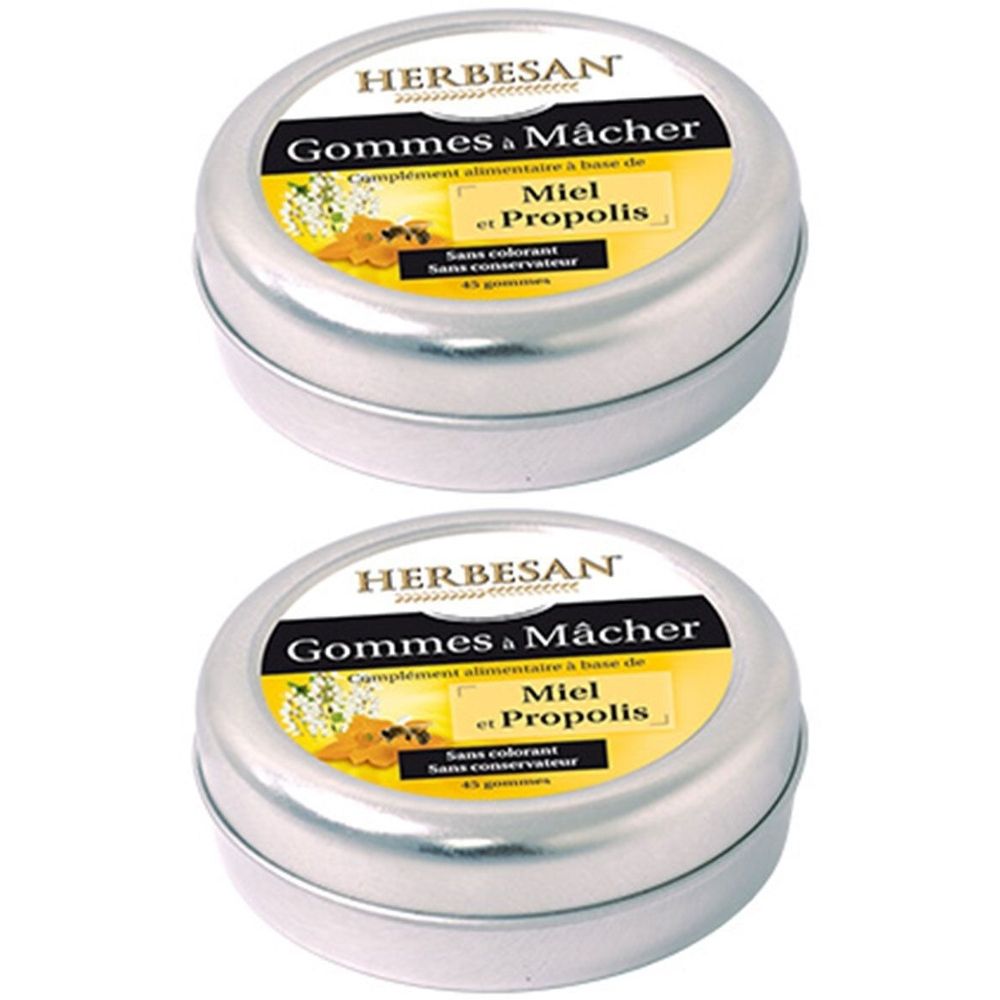 Deux boîtes rondes en métal argenté. Sur le couvercle, le nom "Herbesan" et "Gommes à Mâcher Miel et Propolis" sont visibles.