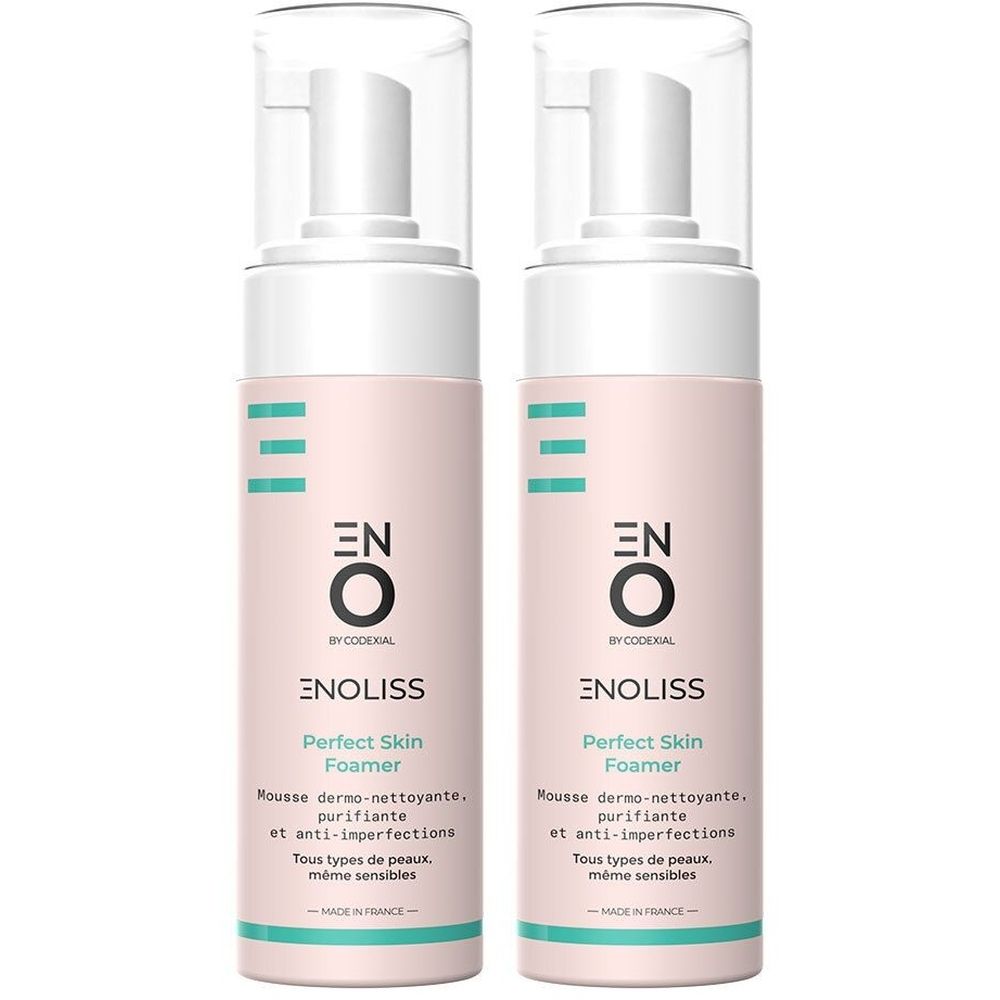 Deux flacons avec pompe blanche et étiquette rose. Inscription : ENO Enoliss Perfect Skin Foamer. Texte en français.
