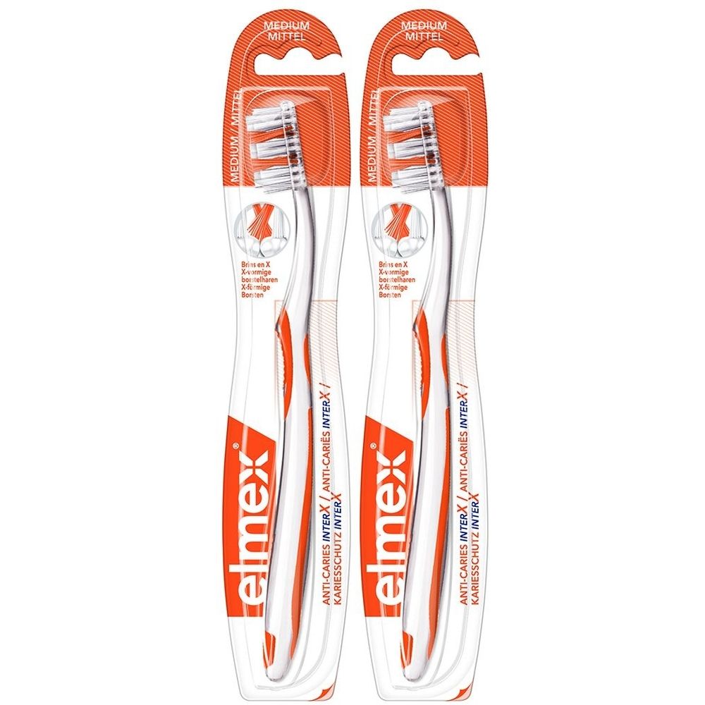 Deux brosses à dents elmex® InterX en emballage. Orange et blanc. Inscription : ANTI-CARIES INTERX, MEDIUM.