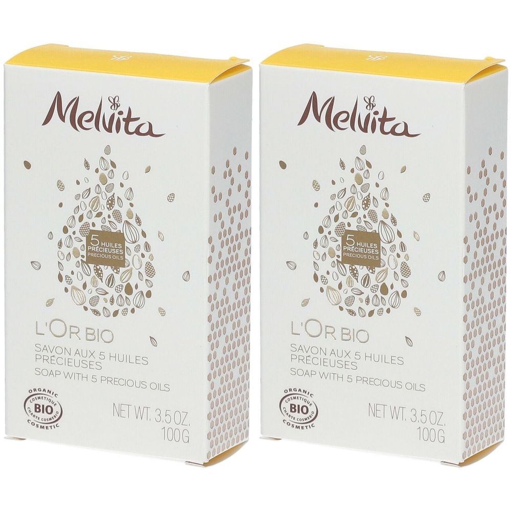 Deux boîtes blanches avec couvercles jaunes. Inscription: Melvita, L'Or Bio, Savon aux 5 Huiles Précieuses, label Bio, 100g.