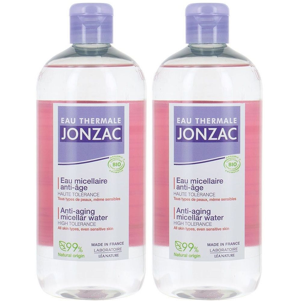 Deux flacons d'eau micellaire Jonzac. Liquide clair teinté de rose. Bouchon et étiquette violets avec texte. Certification bio.