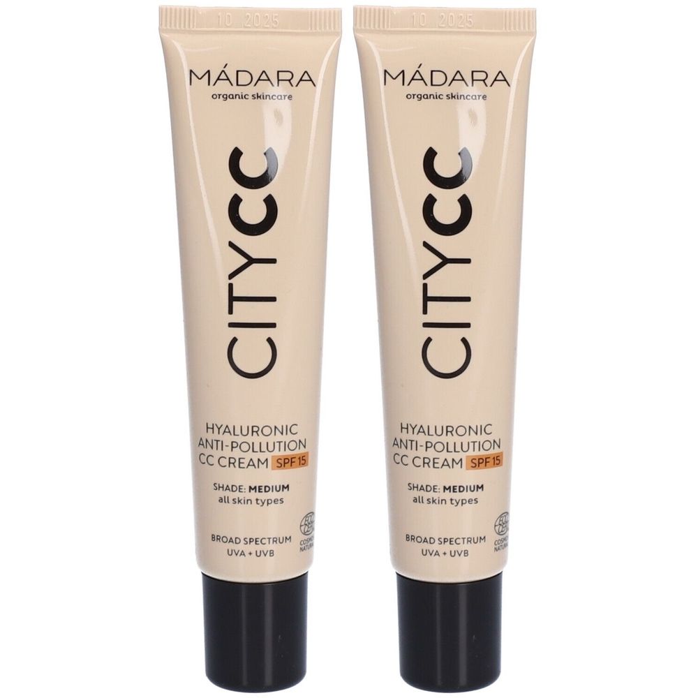 Deux tubes de crème CC anti-pollution Mádara CITY CC SPF 15. Tubes beiges avec bouchons noirs. Texte : CITY CC, acide hyaluronique, SPF 15.
