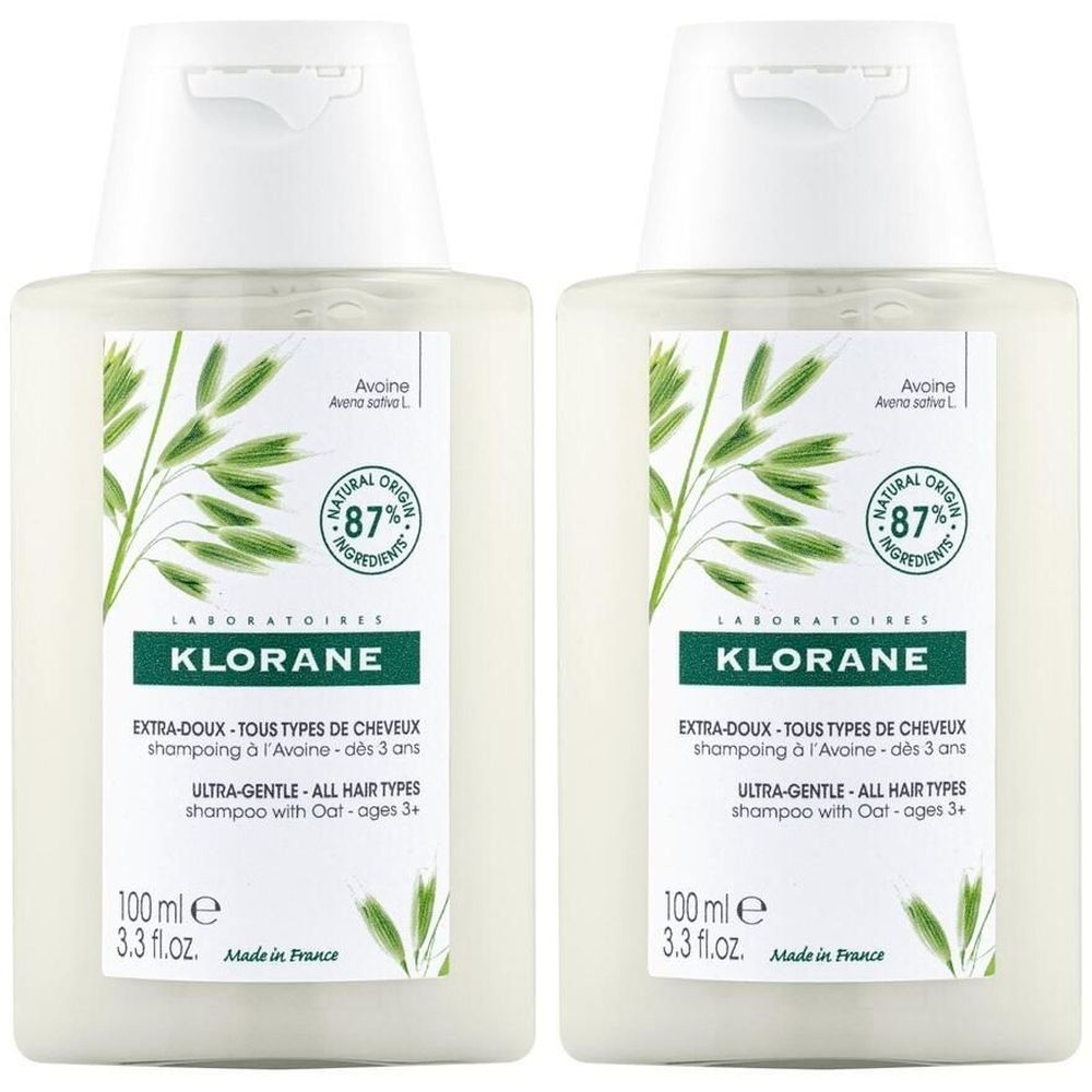 Deux flacons de shampooing KLORANE Avoine. Flacons blancs avec étiquette verte. Texte: Extra-Doux, Tous Types de Cheveux, Ultra-Gentle, 87% d'origine naturelle.