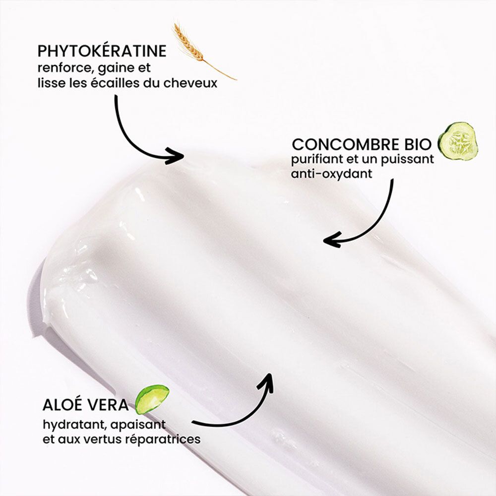 Gros plan d'une crème blanche. Inscriptions: Phyto-kératine, Aloe Vera, concombre bio. Flèches pointant vers les ingrédients.