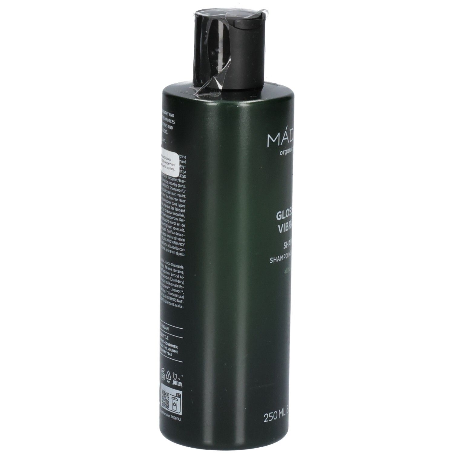 Arrière d'un flacon de shampoing vert. L'étiquette contient les ingrédients et les instructions d'utilisation.