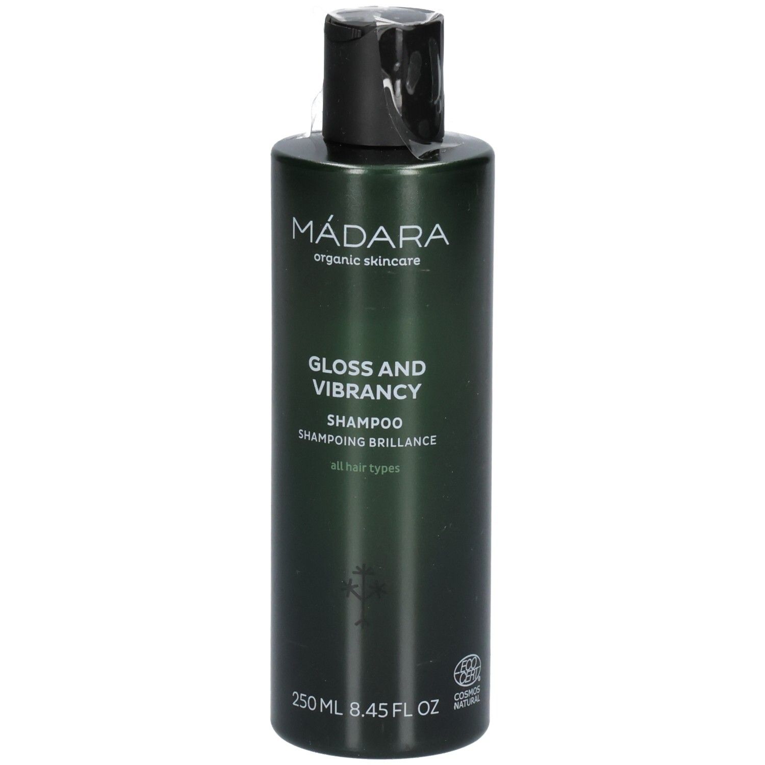 Flacon de shampoing vert avec bouchon noir. Étiquette : MÁDARA, Gloss and Vibrancy Shampoo, 250 ml.