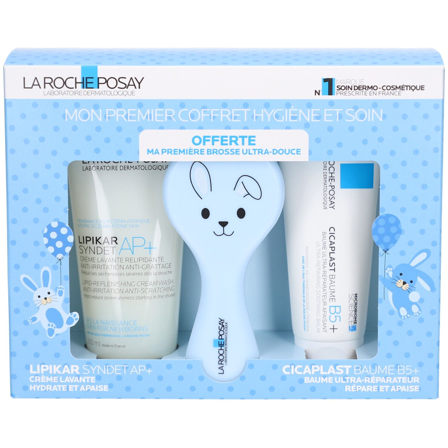 Coffret de soins pour bébé. Contient crème, baume et brosse bleue en forme de lapin. Texte: LA ROCHE POSAY.